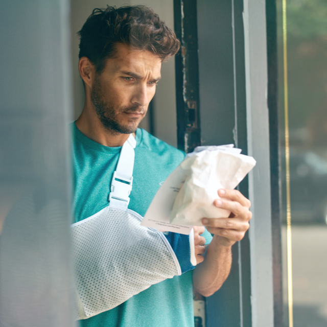 Man in arm sling prescription bag 