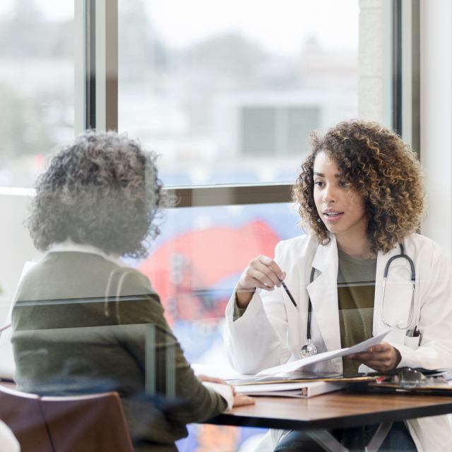 Physician discussing with patient health prevention and recovery