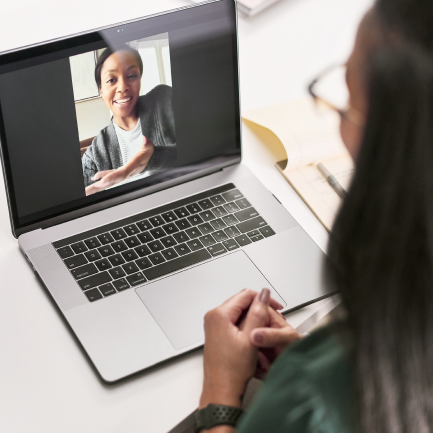 Woman on laptop talking to healthcare worker