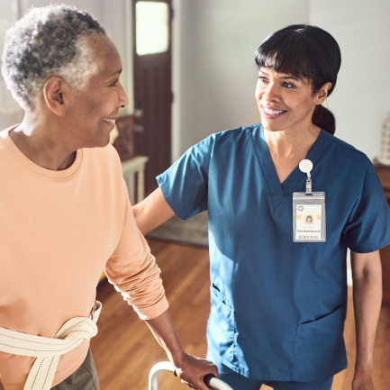 Woman patient standing with walker during medical home visit