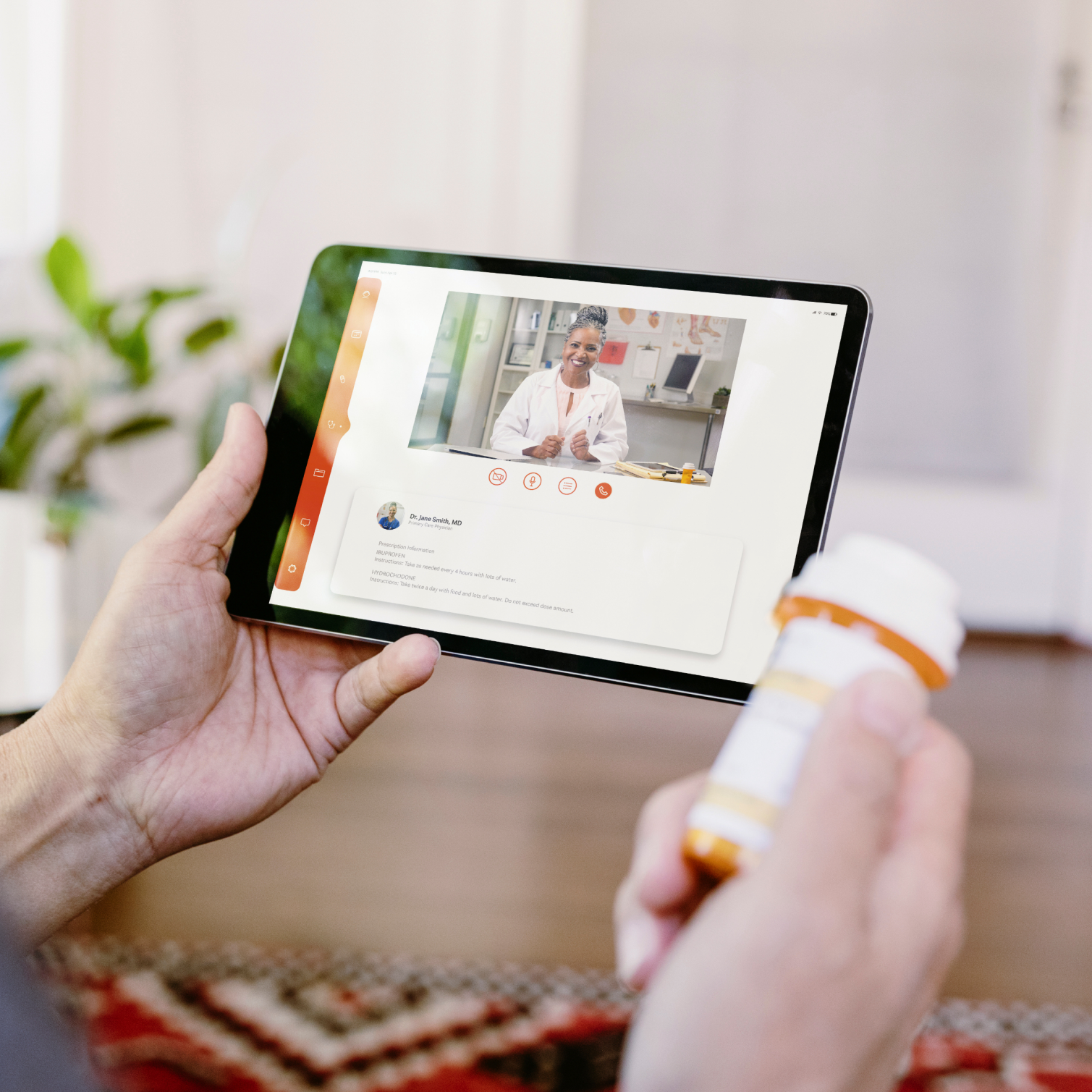 Telehealth appointment on tablet and prescription bottle in right hand