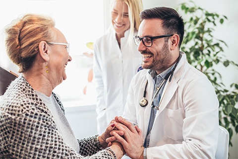 doctor laughing with elderly patient