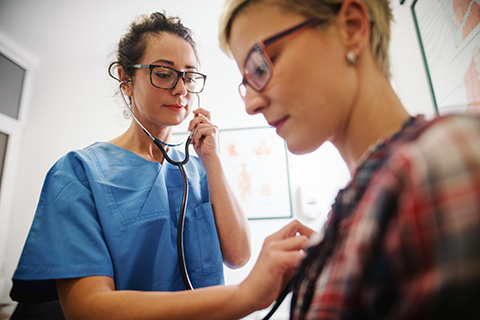 doctor listening to patient's heart