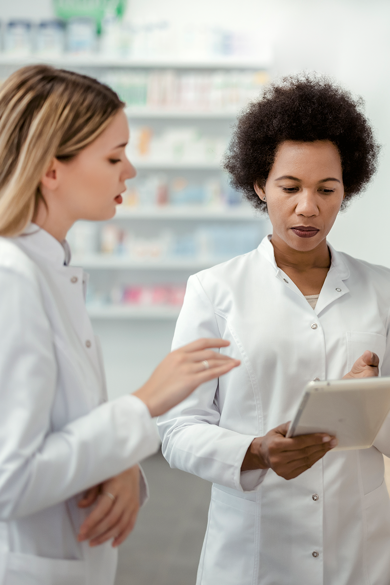 Two pharmacists consulting each other