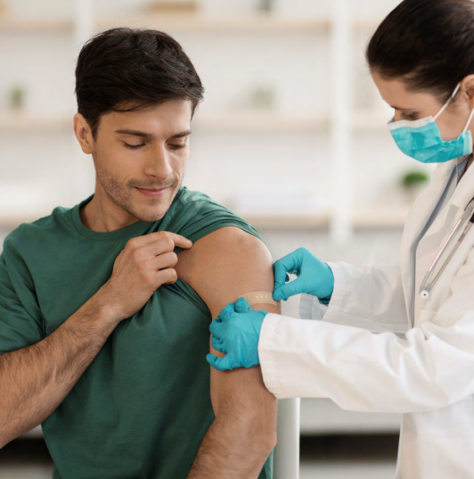 Medical professional places bandage on patient's left arm