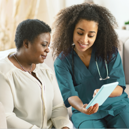 Two women looking at light blue tablet