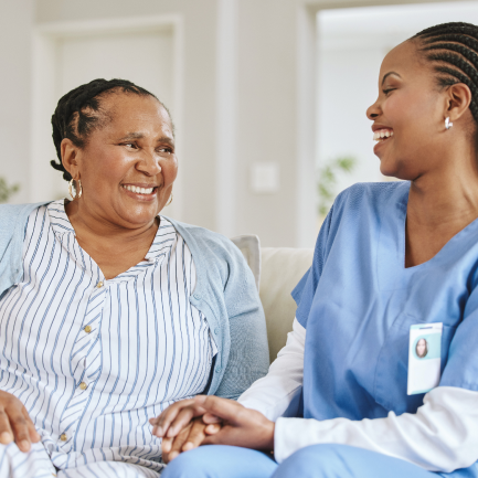 Smiling patient laughing with happy caregiver