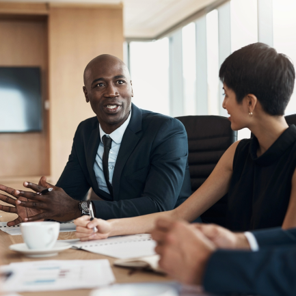 Man and woman in bright conference room 