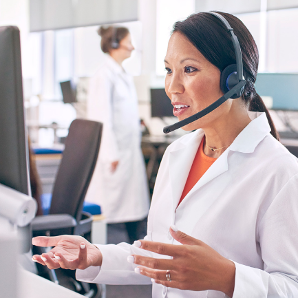 A pharmacist speaks with a patient over the phone.