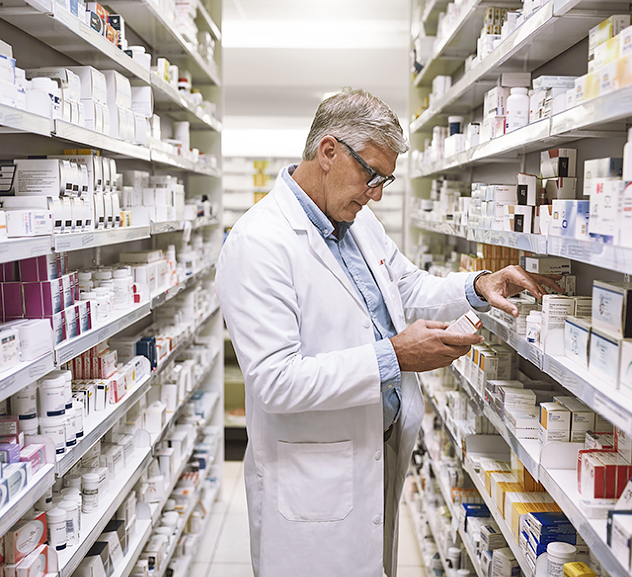 A pharmacist reviews stock.