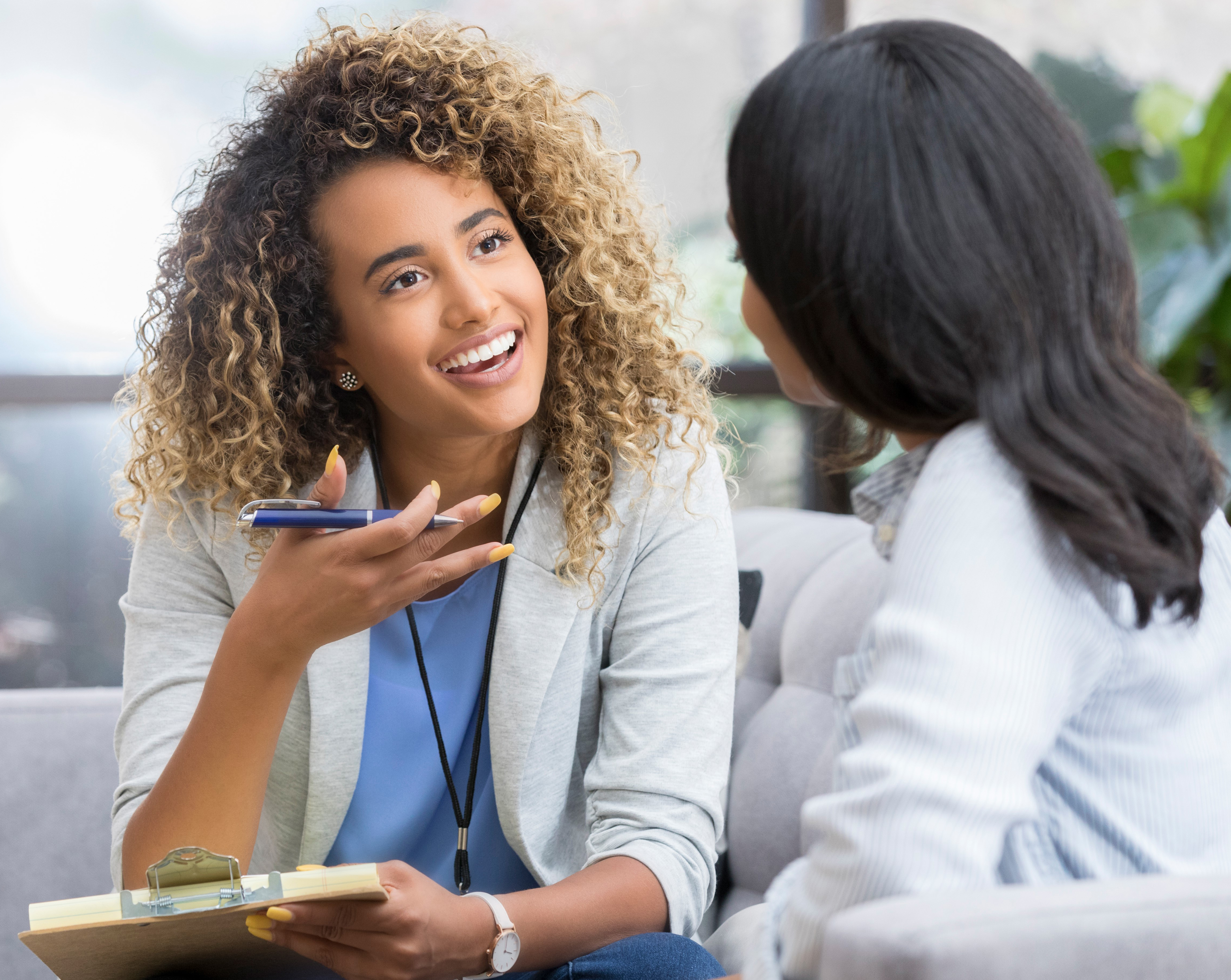 Two women speaking in a professional environment