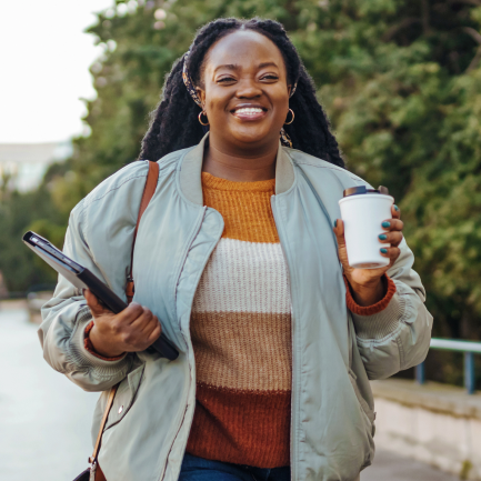 Happy woman taking an active coffee break outside