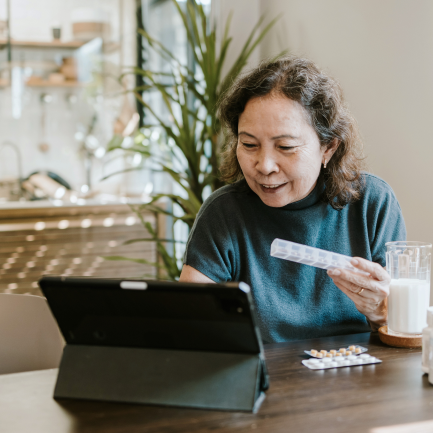 Woman research prescriptions on tablet device