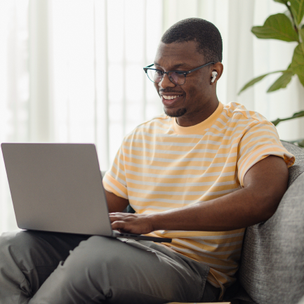 Man sits at home with laptop