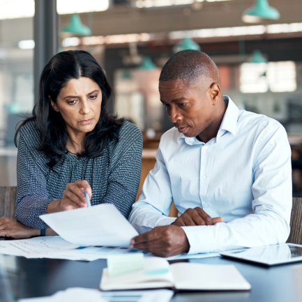 Two people looking down at a paper