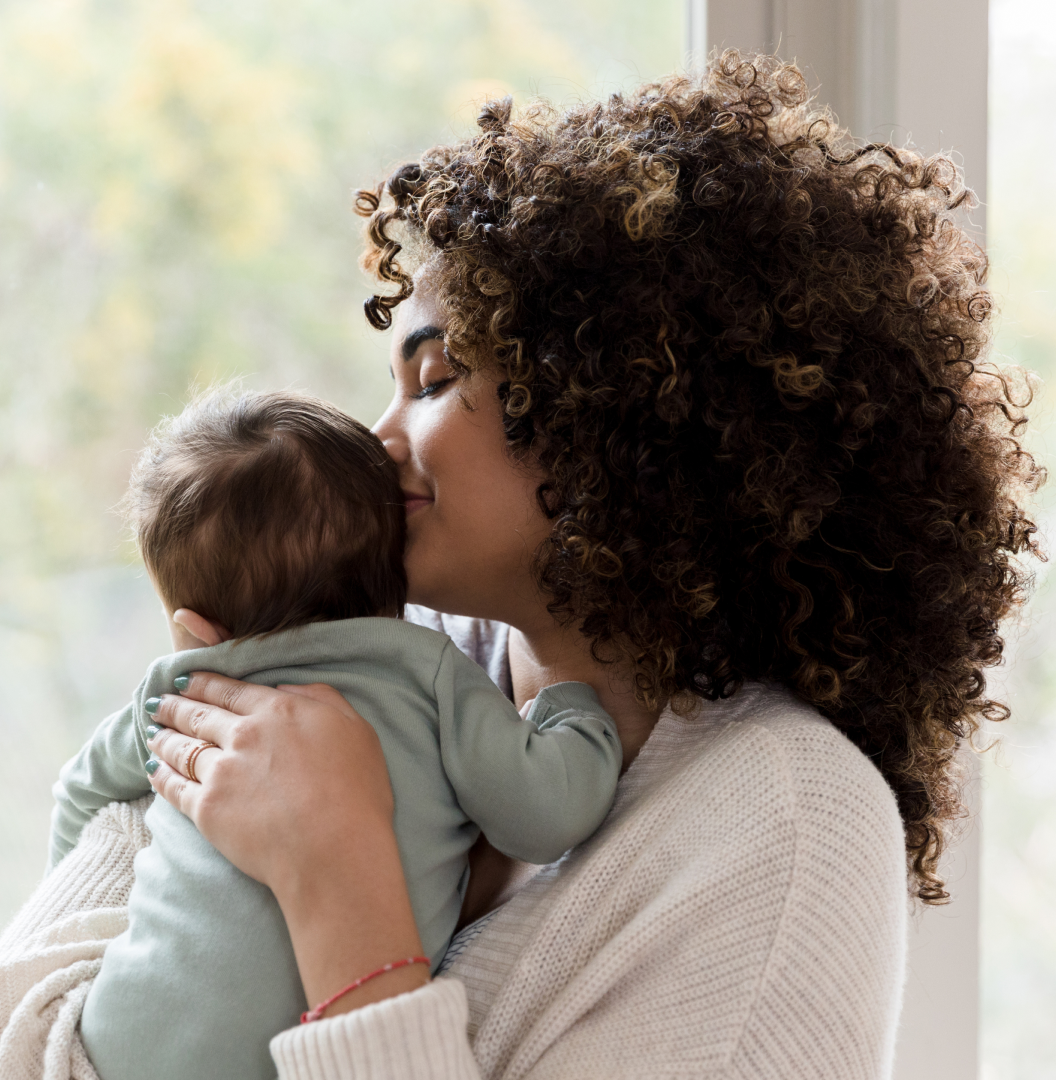 A woman embraces her baby