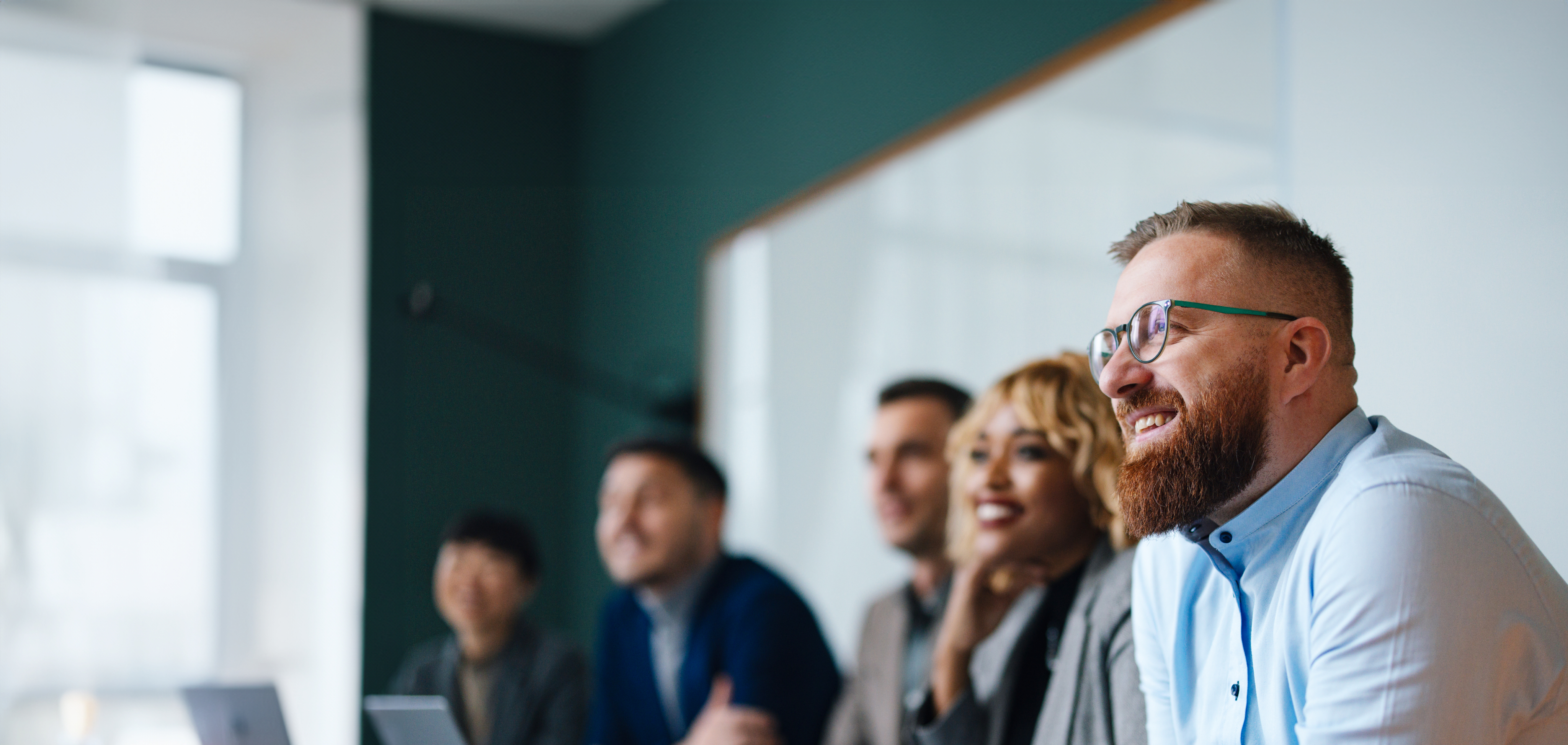 group smiling at conference table