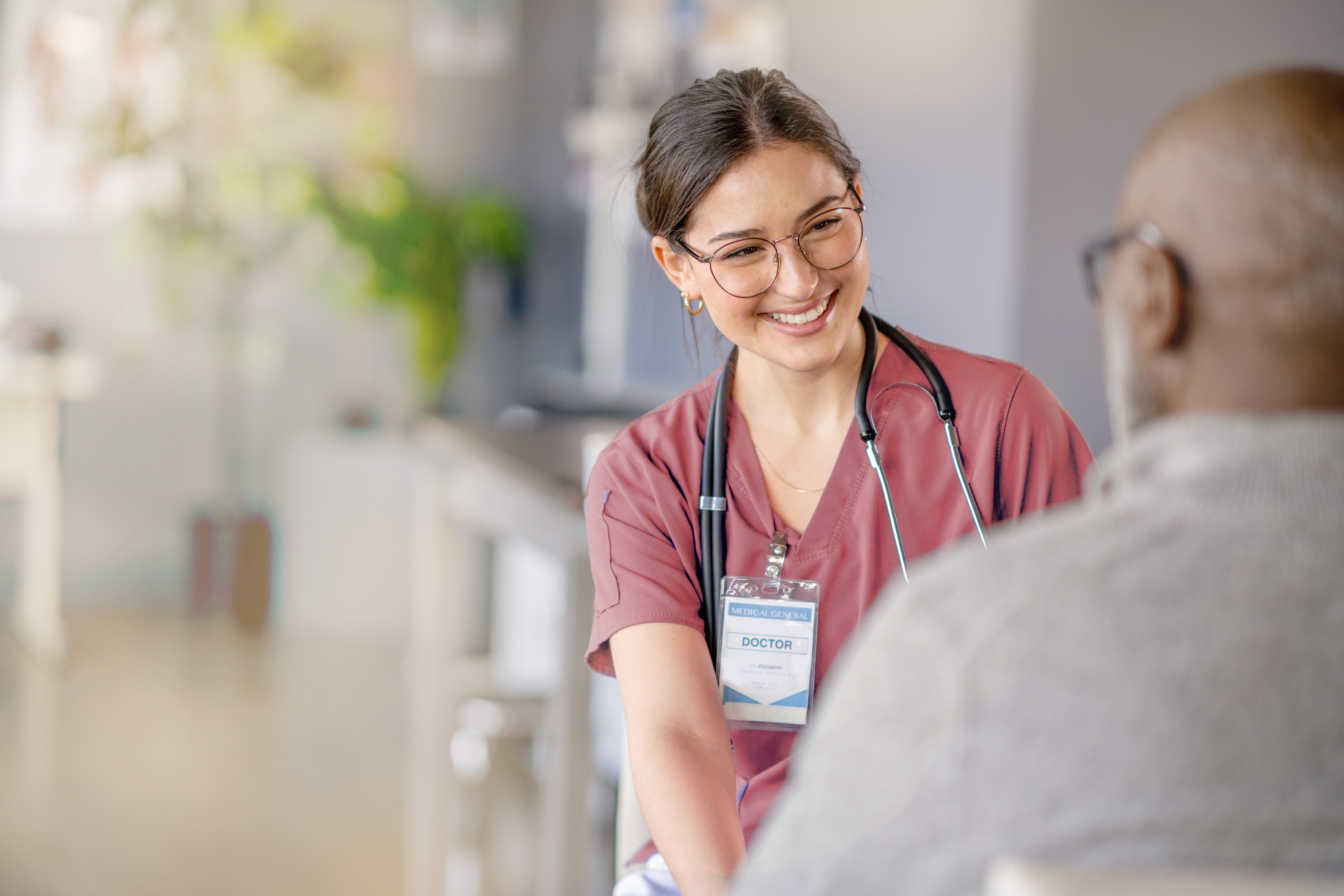 female doctor smiling with black older patient