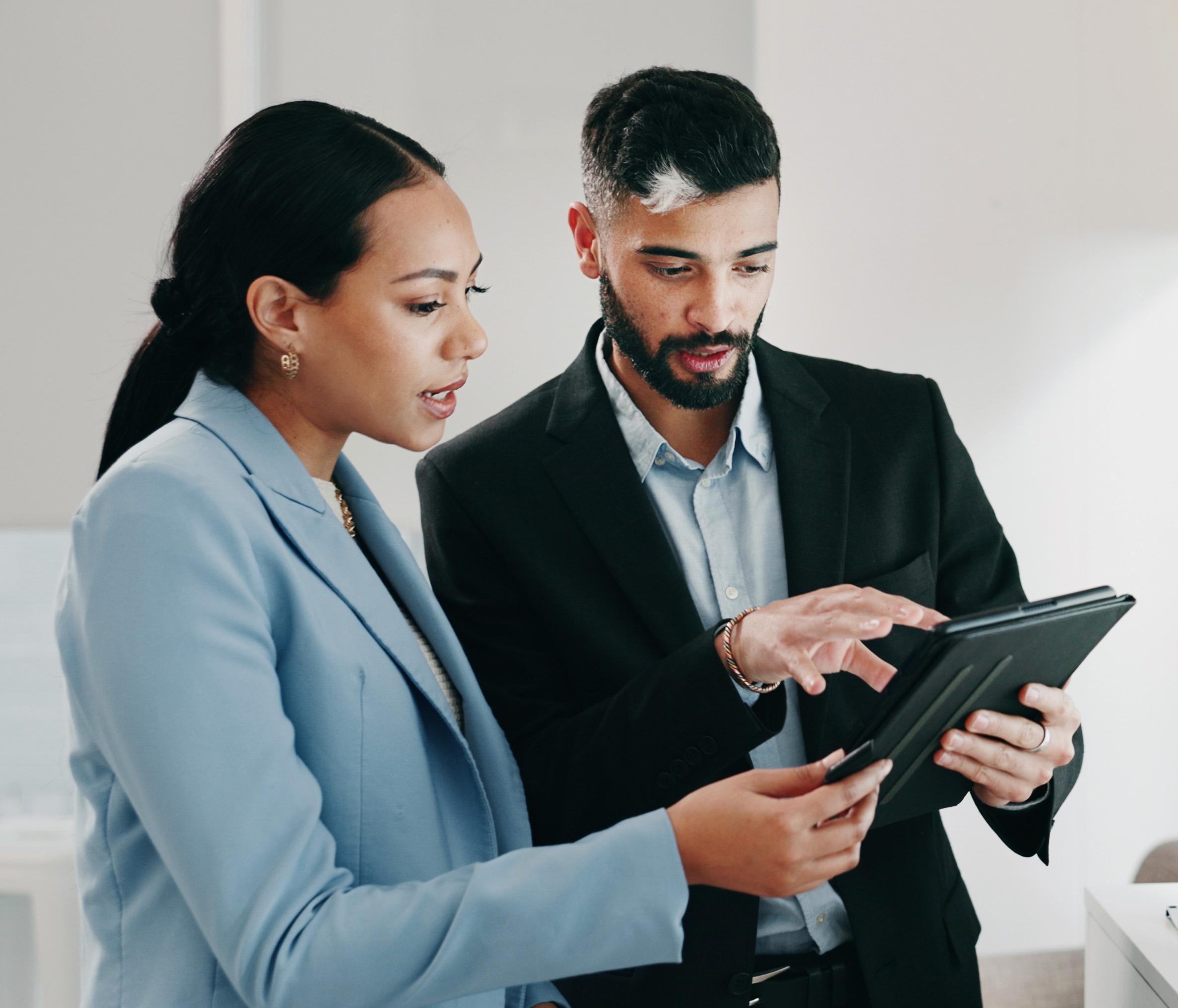 man showing tablet to woman