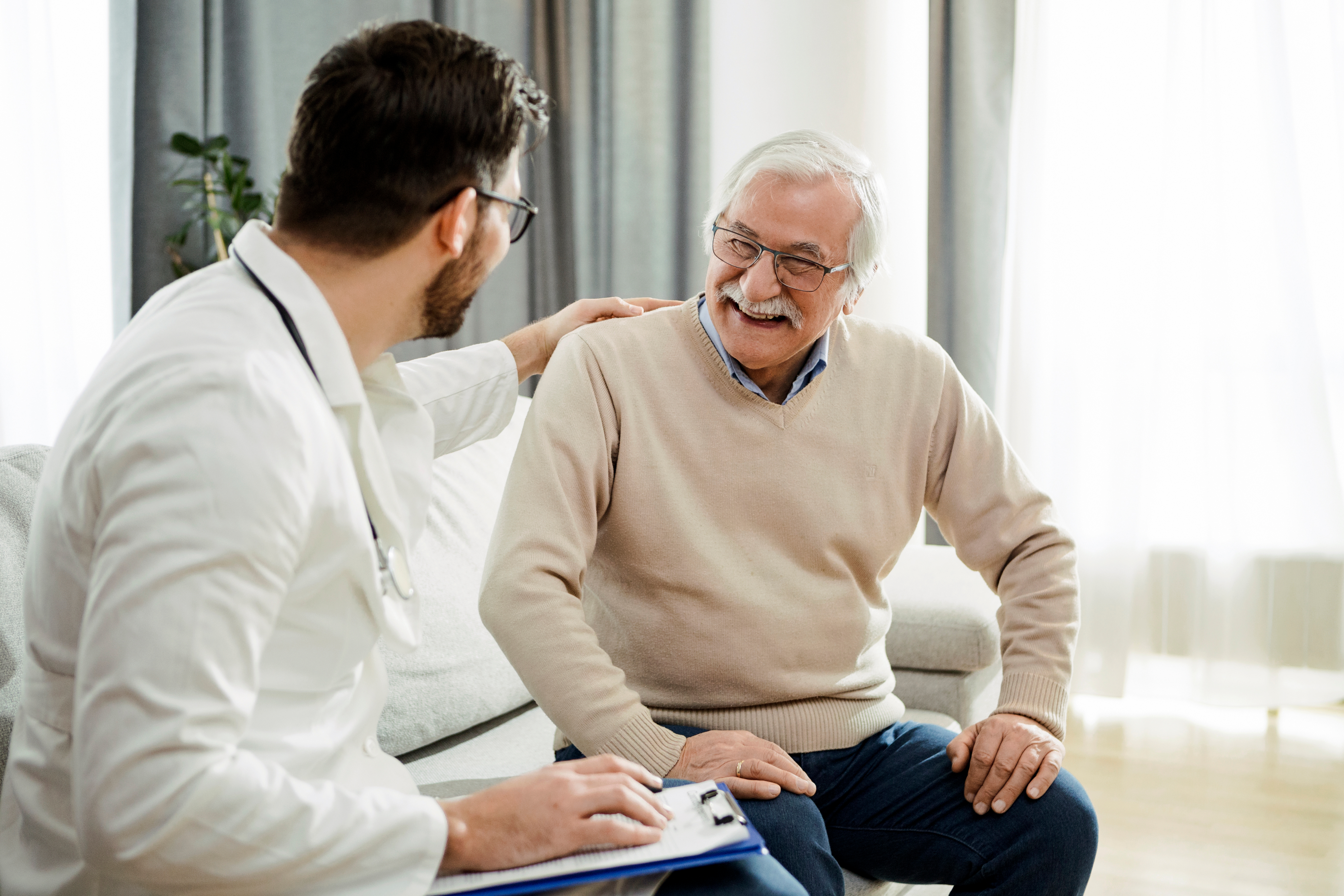 doctor speaking with older patient