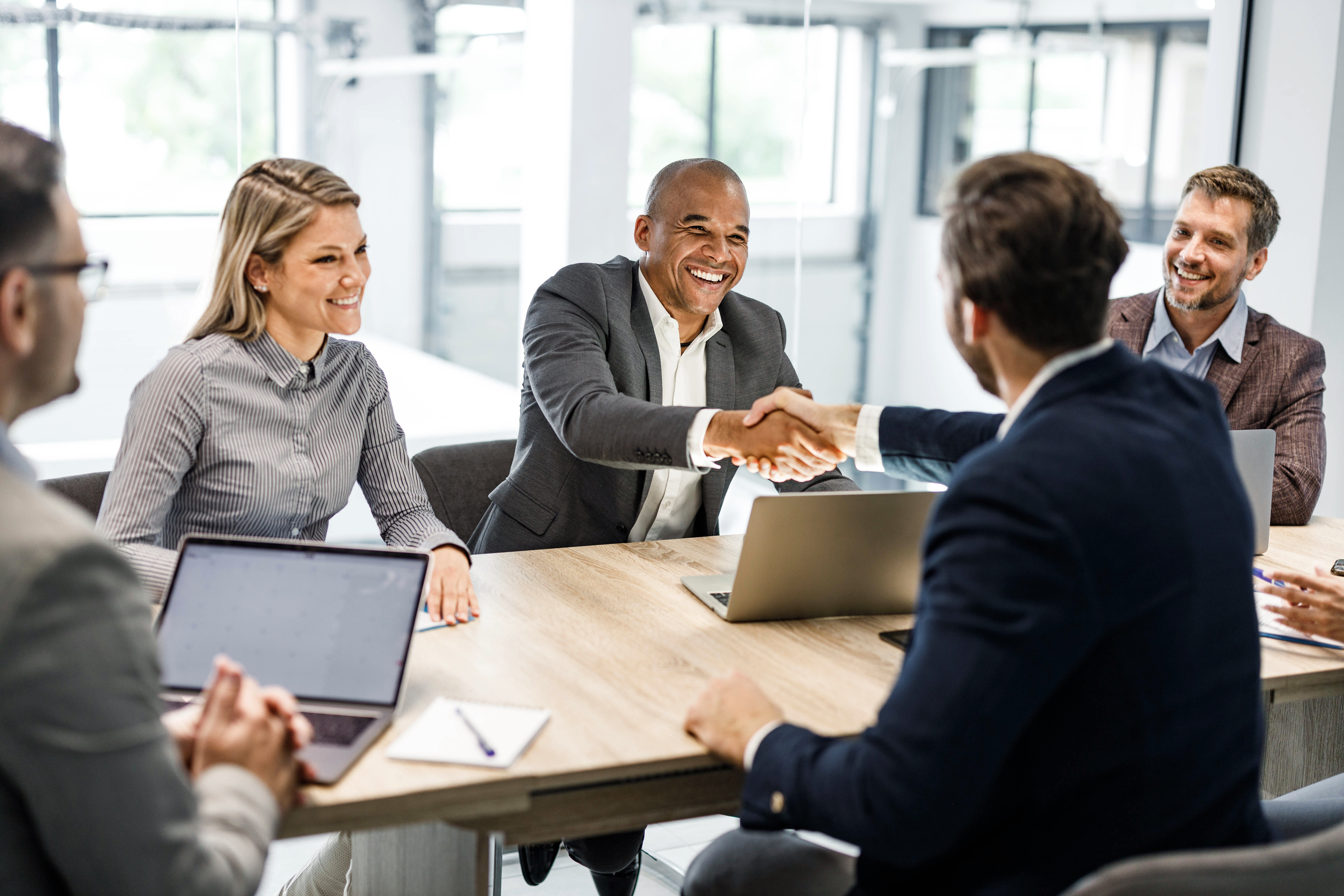 men shaking table at conference table