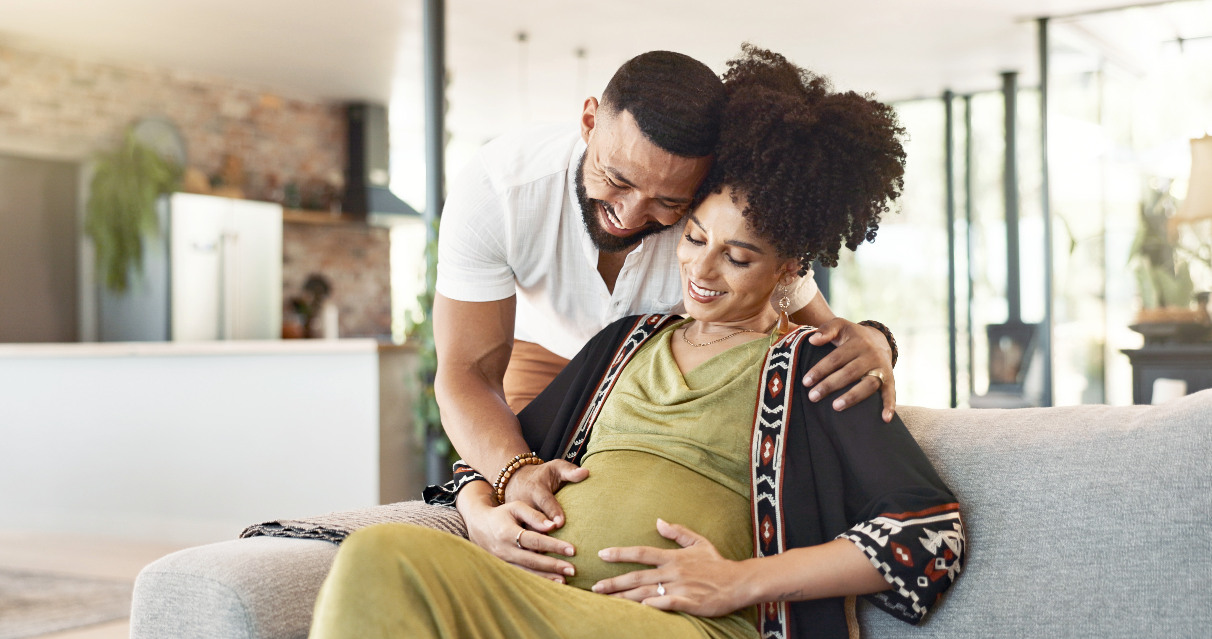 Pregnant woman embraced by husband 