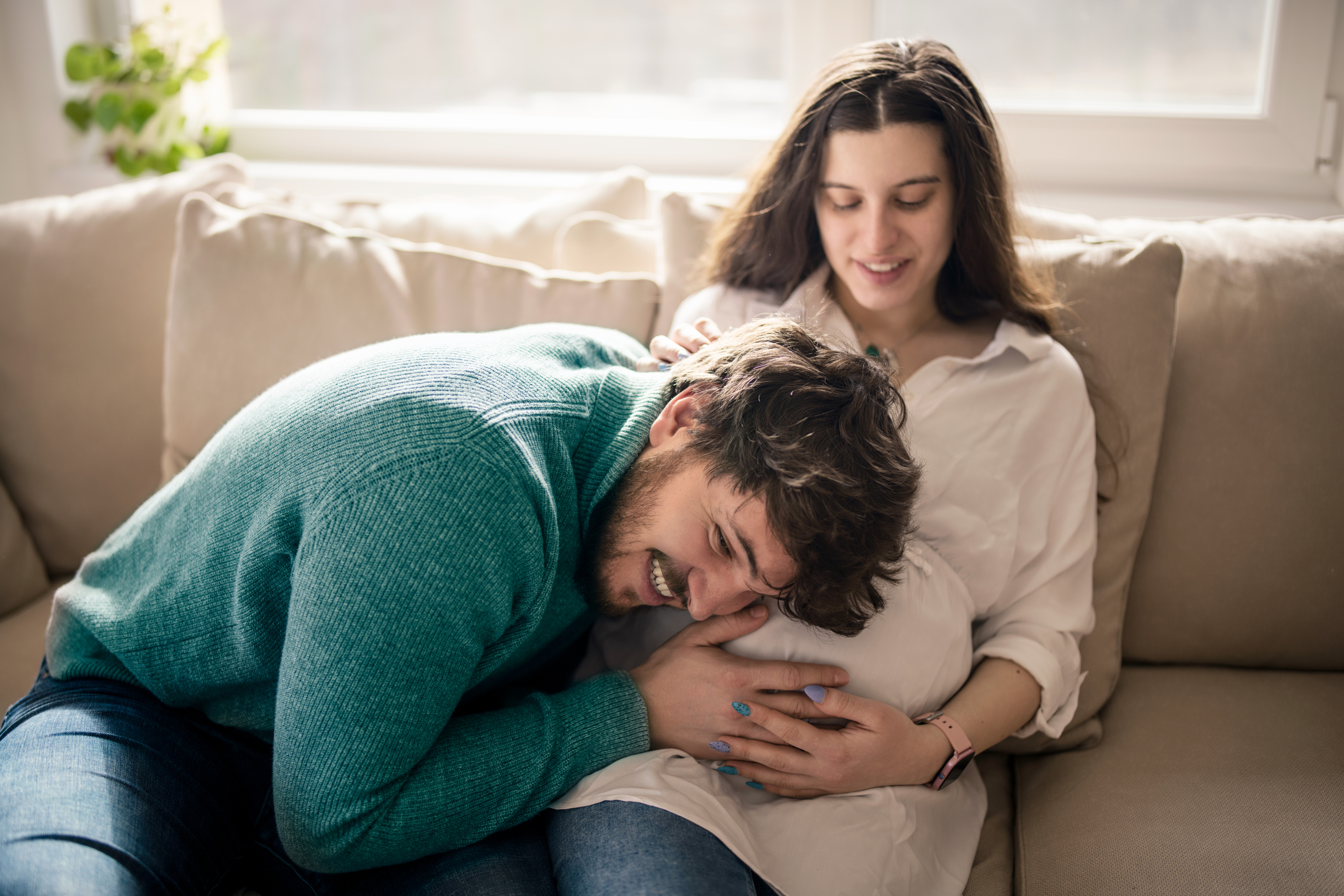 Man resting on pregnant belly