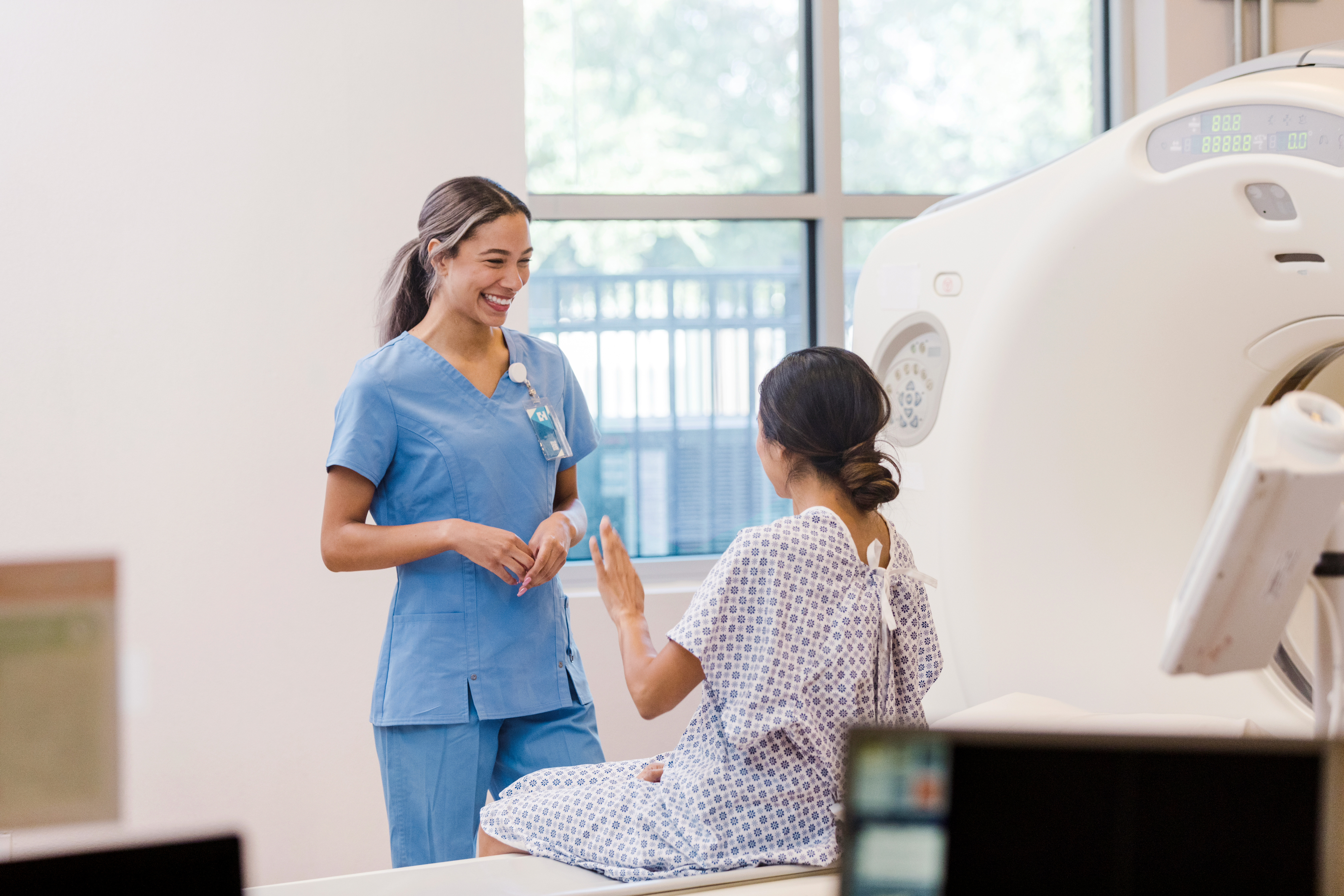 Woman sitting at MRI with attendant