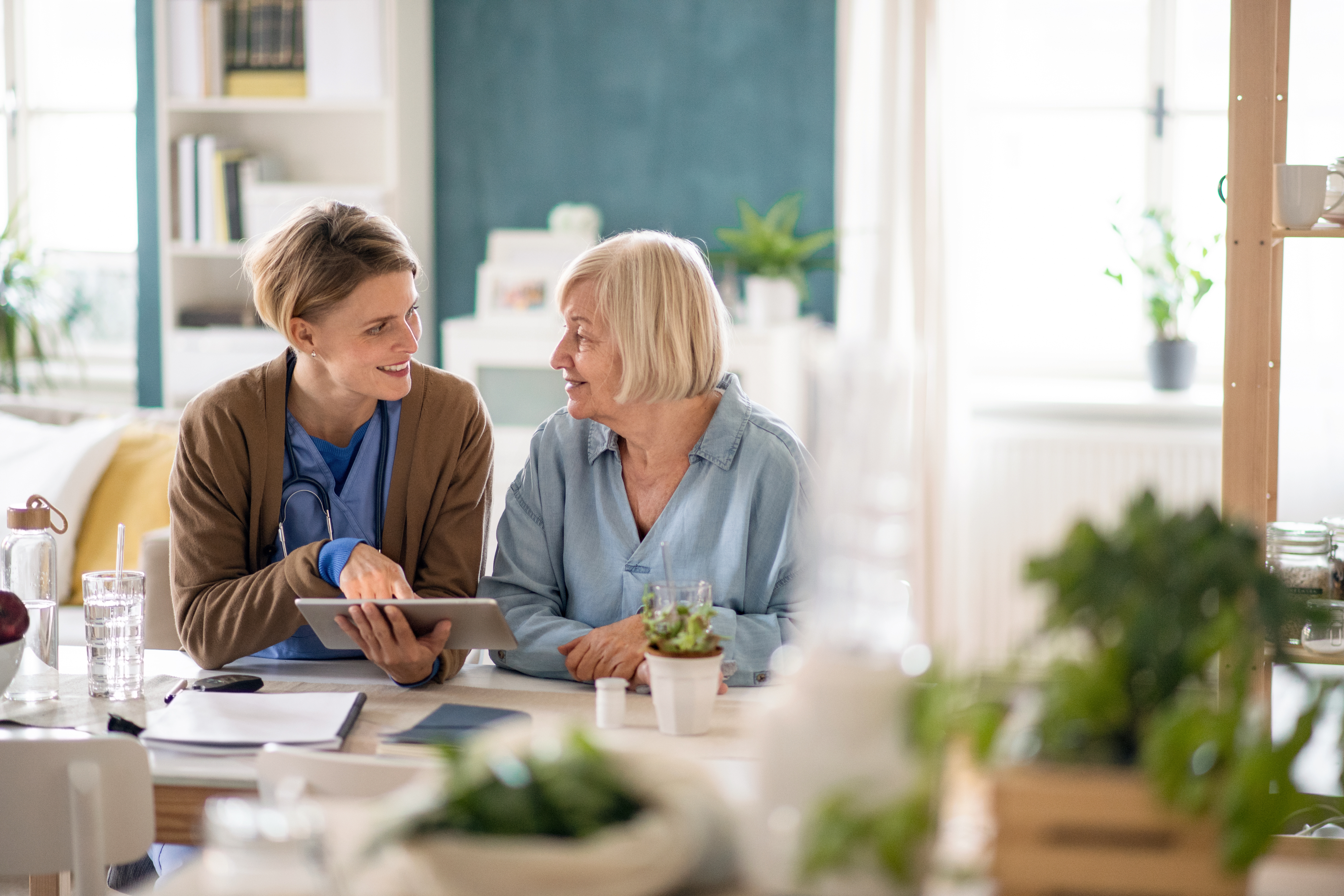 Two women talking with tablet