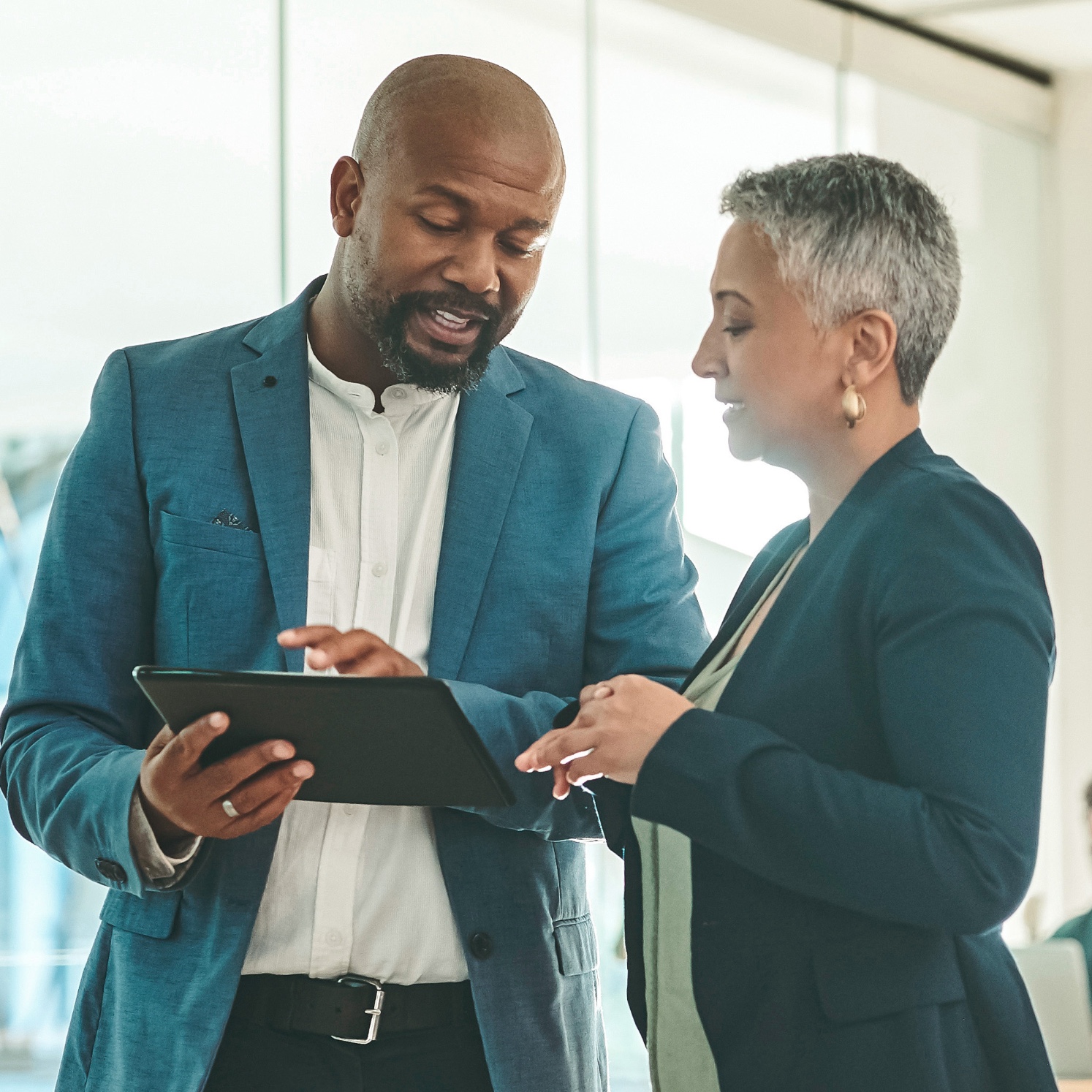 Black male and white female looking at tablet