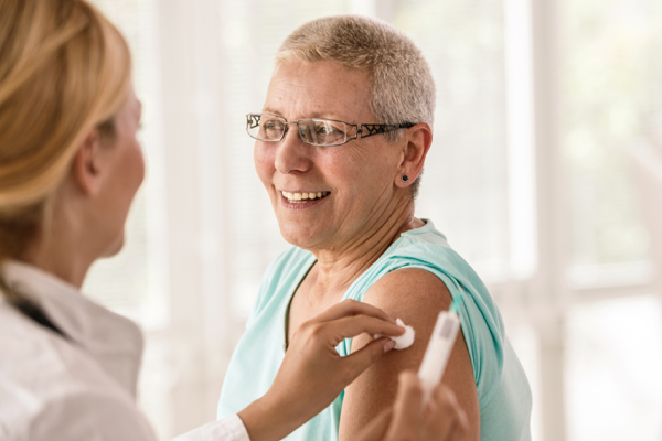 woman receives a vaccine in her upper arm