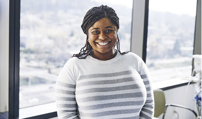 young woman in an office and smiling