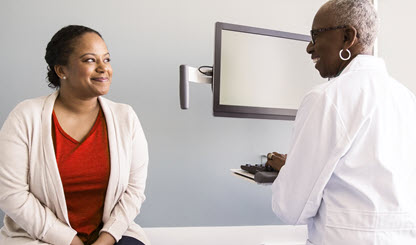 woman visits her health care provider for a consultation