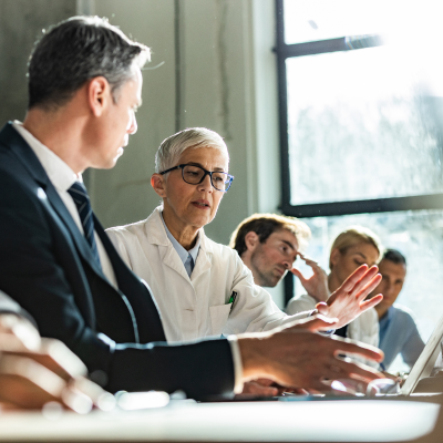 A group of health care providers in a meeting with other professionals