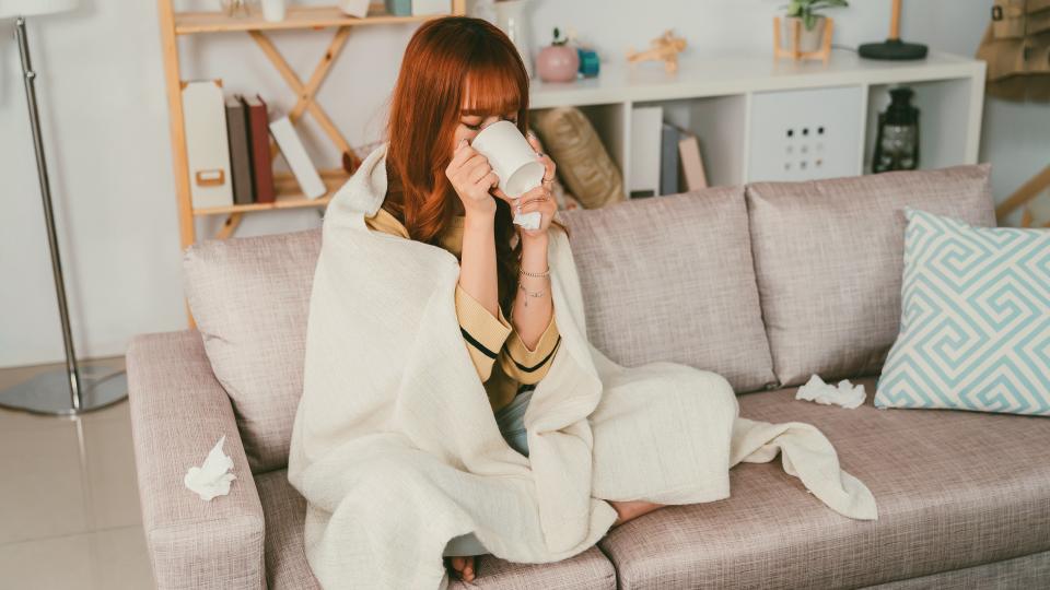 Woman with illness rests on couch