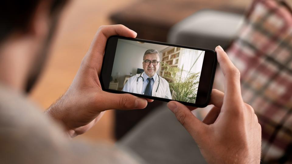 Patient uses phone to speak with physician via video chat