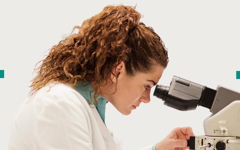 Woman looking through microscope