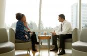 Mother and young child speaking with physician