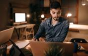 Man working at desk with laptop