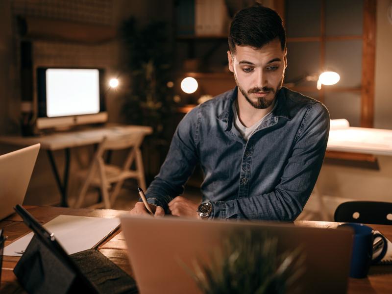 Man working at desk with laptop