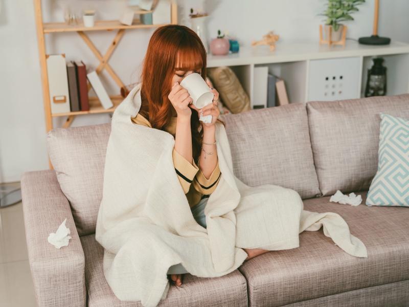 Woman with illness rests on couch