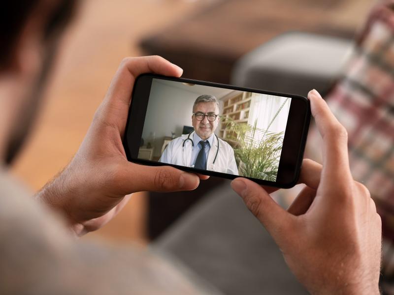 Patient uses phone to speak with physician via video chat