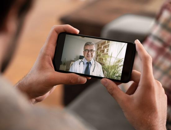 Patient uses phone to speak with physician via video chat