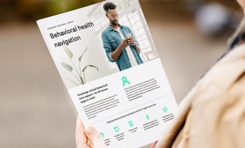 Close-up view of person's hands holding an Evernorth Behavioral Health Navigator document.