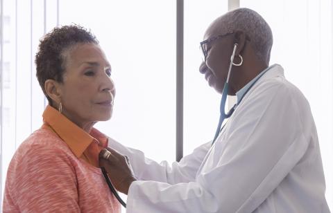 doctor listening to patient's heart