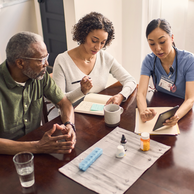 Healthcare workers discussing home-centered care with patient