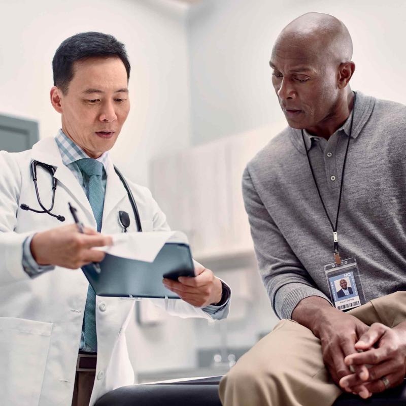 Doctor discussing chart with patient in-person