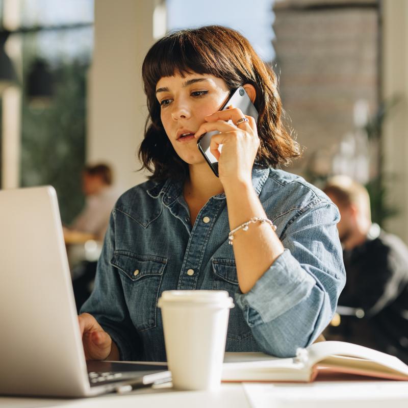 Woman on phone discussing her medical benefits with clinical expert