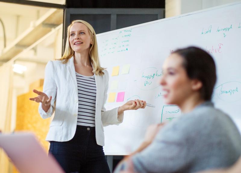 Woman standing in front of white board