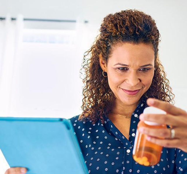 Smiling patient examines prescription bottle